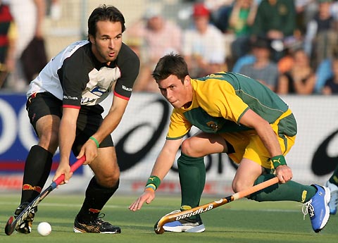 Germany's Tibor Weissenborn (L) fights for the ball with South Africa's Wayne Madsen during their Men's Field Hockey World Cup match at the Warsteiner Hockey Park stadium in Moenchengladbach September 12, 2006.