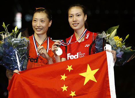 Xie Xingfang of China (R) holds up her gold medal next to silver medallist and compatriot Zhang Ning after their women's singles final match at the World Badminton Championships in Madrid September 24, 2006. 