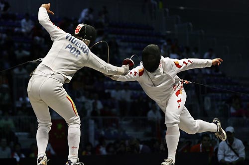 China's Wang Lei (R) competes with Portugal's Joaquim Videira in their men's fencing individual epee final at the World Fencing Championship in Turin October 2, 2006. 