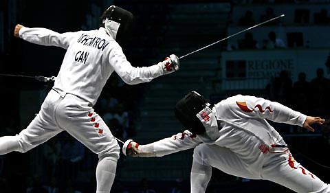 China's Wang Lei competes with Canada's Igor Tikhomirov in their men's fencing individual epee semi-final at the World Fencing Championship in Turin October 2, 2006.