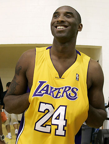 Los Angeles Lakers NBA basketball guard Kobe Bryant shows off the new number on his jersey as he arrives for media day in Los Angeles, October 2, 2006. 