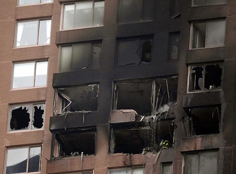 Smoke billows out the windows of a high-rise building after a small aircraft crashed into it in New York City October 11, 2006. 