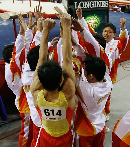 China's gymnastics team celebrates winning the gold medal following the men's team final at the 39th Artistic Gymnastics World Championships in Aarhus, Denmark, October 17, 2006. Team China won the gold medal on Tuesday followed by Russia's silver and Japan's bronze.
