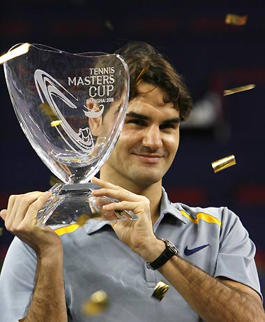 Roger Federer of Switzerland poses with the trophy after winning the Masters Cup tennis tournament in Shanghai November 19, 2006. 