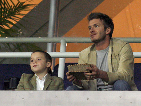 Real Madrid's David Beckham (R) and his son Brooklyn watch his team's Champions League Group E soccer match against Olympique Lyon at Santiago Bernabeu stadium in Madrid November 21, 2006.