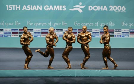 (L-R) Iran's Saman Sarabi, Indonesia's Syafrizaldy, Japan's Kenji Kondo, Bahrain's Sayed Faisal Husain and Singapore's Chua Ling Fung compete in the men's under-70kg bodybuilding event at the Asian Games in Doha December 8, 2006.