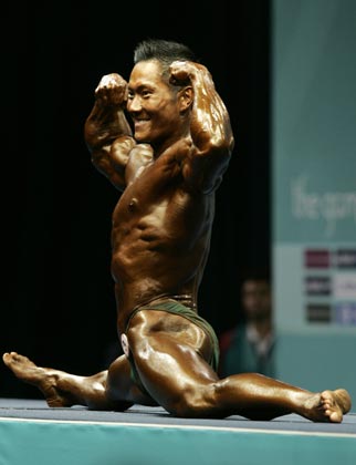 Singapore's Chua Ling Fung competes in the men's minus 70 kilograms bodybuilding event at the Asian Games in Doha December 8, 2006. Chua won the gold medal. 