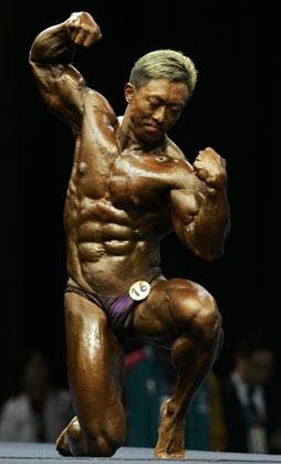 Macau's Chong Ka-lap competes in the men's minus 65 kilograms bodybuilding event at the Asian Games in Doha December 8, 2006. Chong won the bronze medal. 