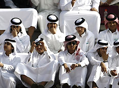 Spectators watch the athletics heats at the 15th Asian Games in Doha December 10, 2006.