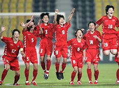 North Korea's players celebrate after beating Japan in their women's soccer final at the 15th Asian Games in Doha December 13, 2006. 