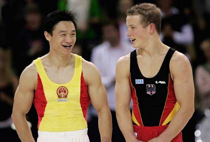 China's Yang Wei (L) and Germany's Fabian Hambuechen chat on the podium at the end of the all-around final at the 39th Artistic Gymnastics World Championships in Aarhus, Denmark, October 19, 2006. China's Yang Wei won the gold medal on Thursday followed by Japan's silver medalist Hiroyuki Tomita and Germany's bronze medal winner Fabian Hambuechen.