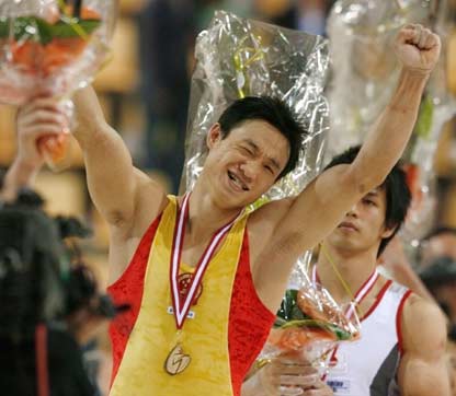 Gold medallist Yang Wei of China blinks with his eye to his supporters during the podium ceremony for the men's individual all-around final at the 39th Artistic Gymnastics World Championships in Aarhus, Denmark, October 19, 2006. China's Yang Wei won the gold medal on Thursday followed by Japan's silver medallist Hiroyuki Tomita and Germany's bronze medal Fabian Hambuechen.