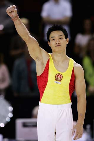 China's Yang Wei celebrate the gold medal in all-around final at the 39th Artistic Gymnastics World Championships in Aarhus, Denmark, October 19, 2006. China's Yang won the gold medal on Thursday followed by Japan's silver medallist Hiroyuki Tomita and Germany's bronze medal winner Fabian Hambuechen.