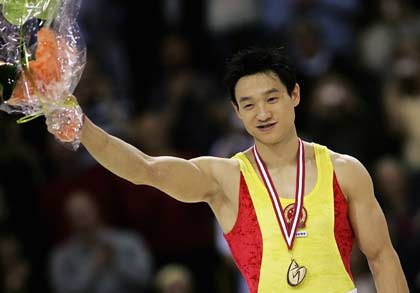 China's Yang Wei celebrate the gold medal in all-around final at the 39th Artistic Gymnastics World Championships in Aarhus, Denmark, October 19, 2006. China's Yang won the gold medal on Thursday followed by Japan's silver medallist Hiroyuki Tomita and Germany's bronze medal winner Fabian Hambuechen.