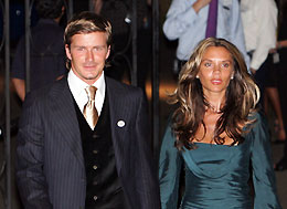 England's soccer captain David Beckham (L) and his wife Victoria leave a dinner reception at the British High Commissioner's residence in Singapore in this July 4, 2005 file photo. 