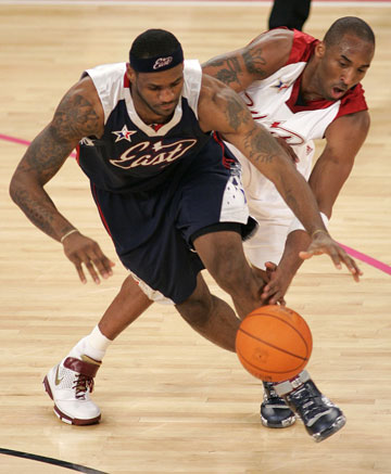 NBA All-Stars LeBron James and Kobe Bryant fight for the ball during the 