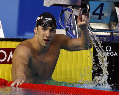 Michael Phelps of the U.S. gestures after winning the men's 200m butterfly swimming final at the World Aquatics Championship in Melbourne March 28, 2007. Phelps won the race with a new world record time of 1:52.09.