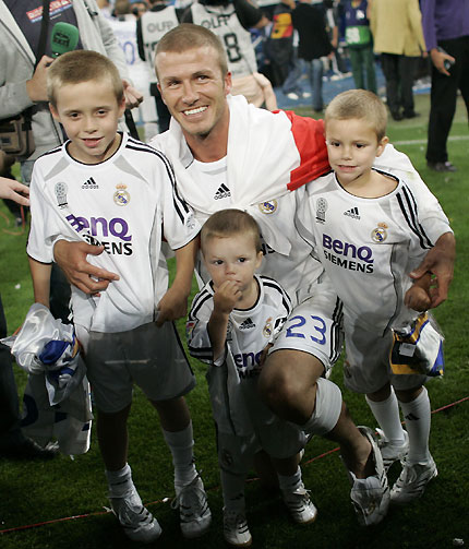 Real Madrid's David Beckham celebrates with his children after their Spanish First Division soccer victory over Real Mallorca at the Santiago Bernabeu stadium in Madrid June 17, 2007. 
