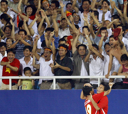 Vietnam's Huynh Cuang Thanh (R) celebrates with team mate Phan Van Tai Em after scoring his team's first goal against the United Arab Emirates in the second half of their 2007 AFC Asian Cup Group B soccer match at My Dinh Stadium in Hanoi July 8, 2007. 