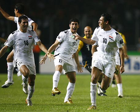 Iraq's (from L) Mahdi Karim, Louay Salah Hassan and Younis Mahmoud celebrate after winning their match against Saudi Arabia at the 2007 AFC Asian Cup soccer competition at the Gelora Bung Karno stadium in Jakarta July 29, 2007.