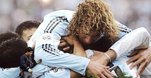 A man works on a giant billboard 