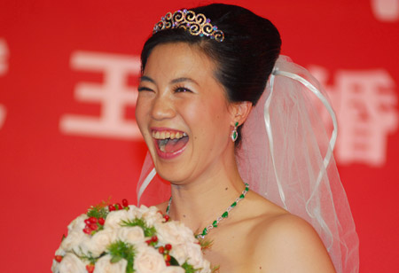 China's four-time Olympic table tennis gold medalist Wang Nan laughs at her wedding ceremony, September 27, 2008. Wang and her long-time partner Guo Bin tied the knot onboard a yacht in Yantai, Shandong Province on Saturday as Wang's teammate Ma Lin and Japan's most popular table tennis star Ai Fukuhara were best man and maid of honor respectively. [Xinhua]