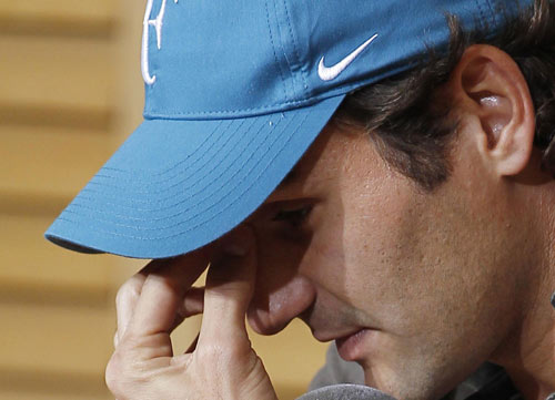 Federer shrugs off defeat with a wry smile