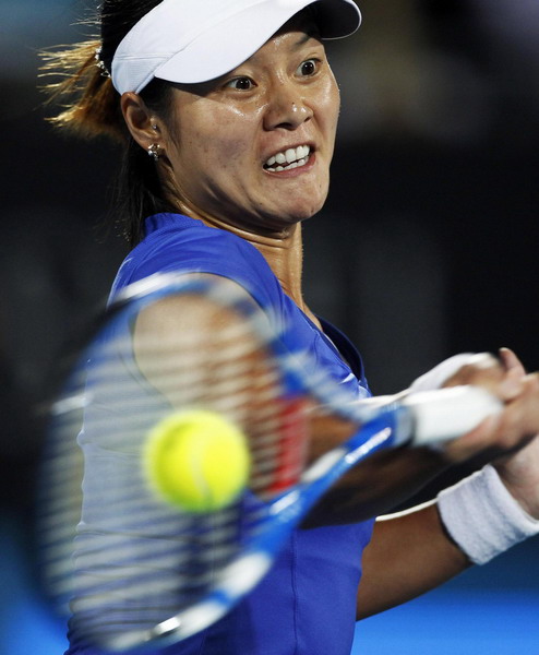 Li Na of China returns the ball to Kim Clijsters of Belgium during the ...