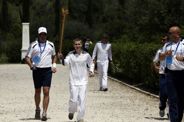 London Olympics flame lit in Olympia, torch relay begins