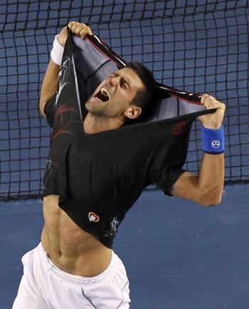 Novak Djokovic of Serbia tears his shirt as he celebrates after defeating Rafael Nadal of Spain in their men's singles final match at the Australian Open tennis tournament in Melbourne, Jan 30, 2012. World's top 10 sports news in 2012