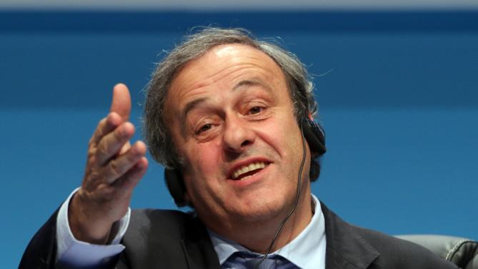 Platini re-elected as Blatter sits through criticism