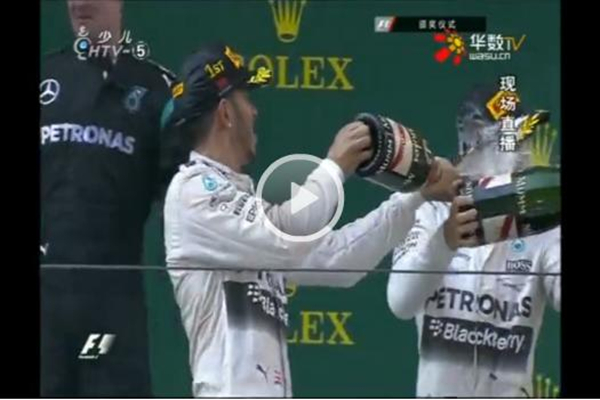 F1 ace urged to apologize after spraying Chinese hostess with champagne