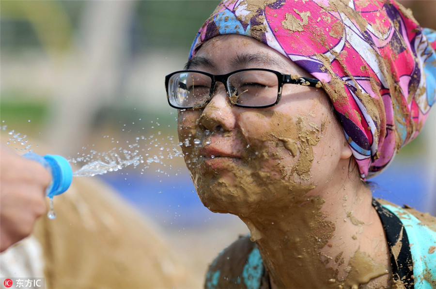 Swamp soccer: Players battle for ball in Nanjing