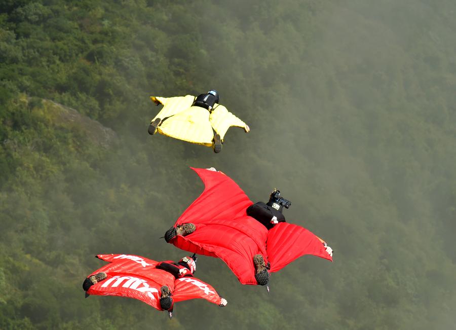 Daredevil wingsuit jumpers glide over Yunnan