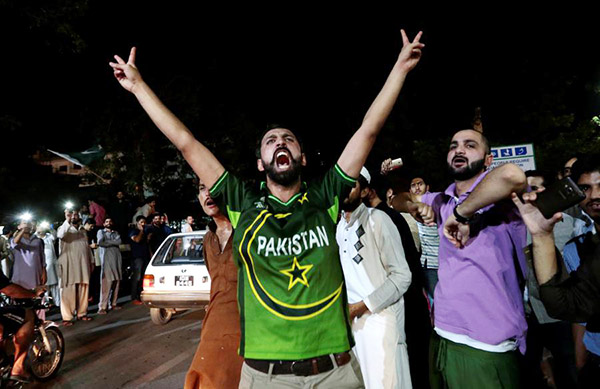 With gunfire and sweets, cricket-obsessed Pakistanis savour victory over India