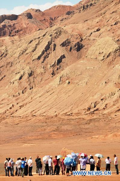 Tourists visit Flaming Mountain in Xinjiang