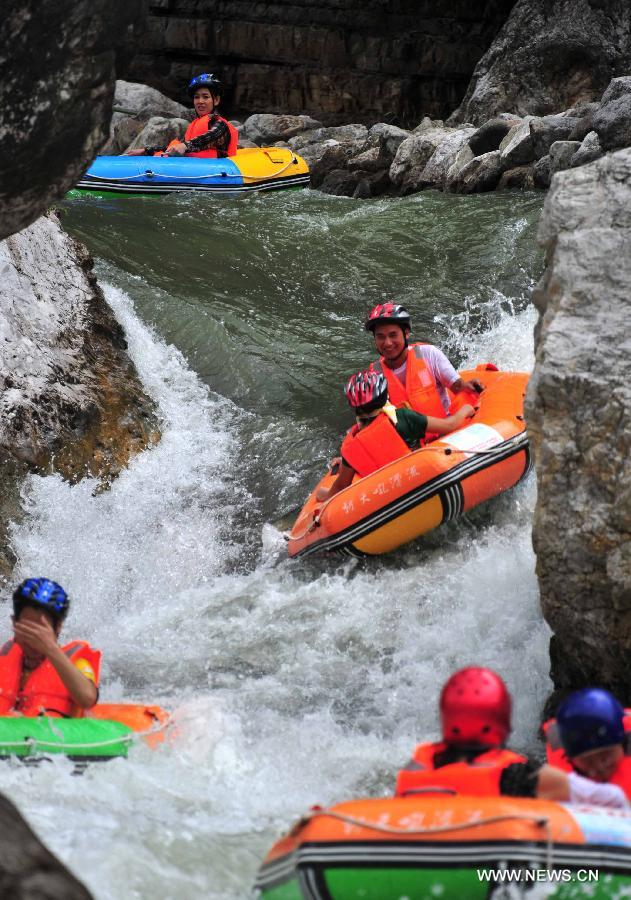 Tourists enjoy rafting in C China