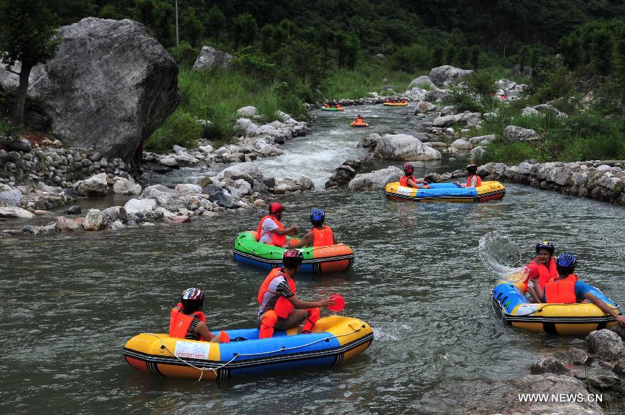 Tourists enjoy rafting in C China