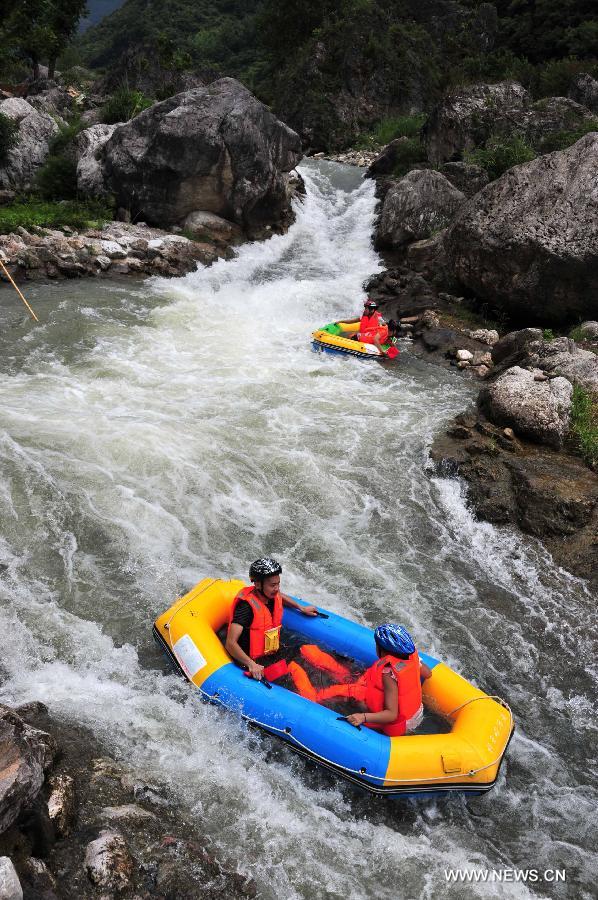 Tourists enjoy rafting in C China