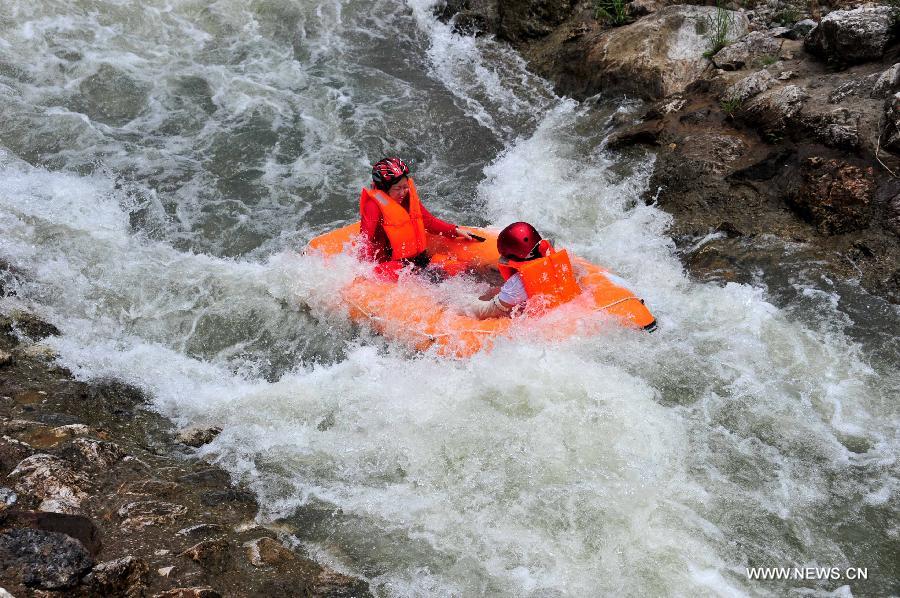 Tourists enjoy rafting in C China