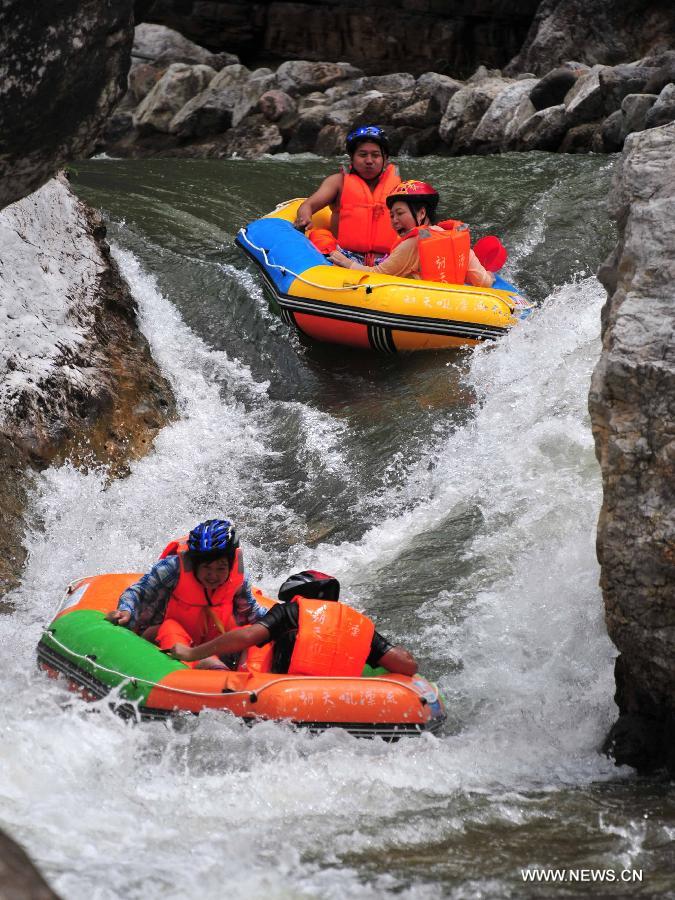 Tourists enjoy rafting in C China