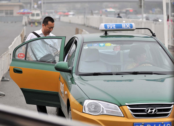 A man takes a taxi near Beijing Railway Station