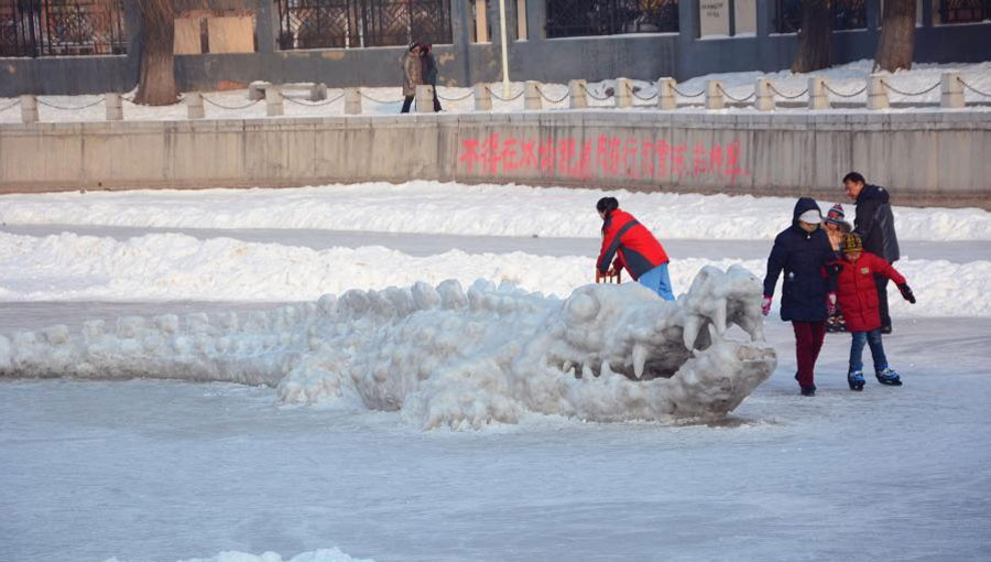 Giant crocodile sculpture made with snow