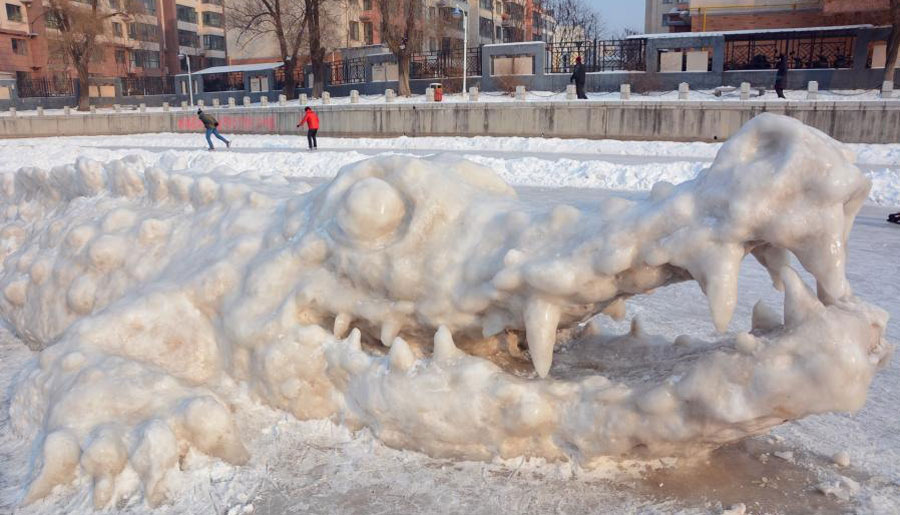 Giant crocodile sculpture made with snow