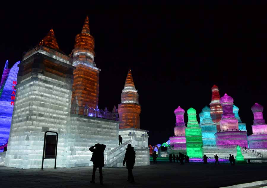 Tourists view shimmering ice sculptures in China's Harbin