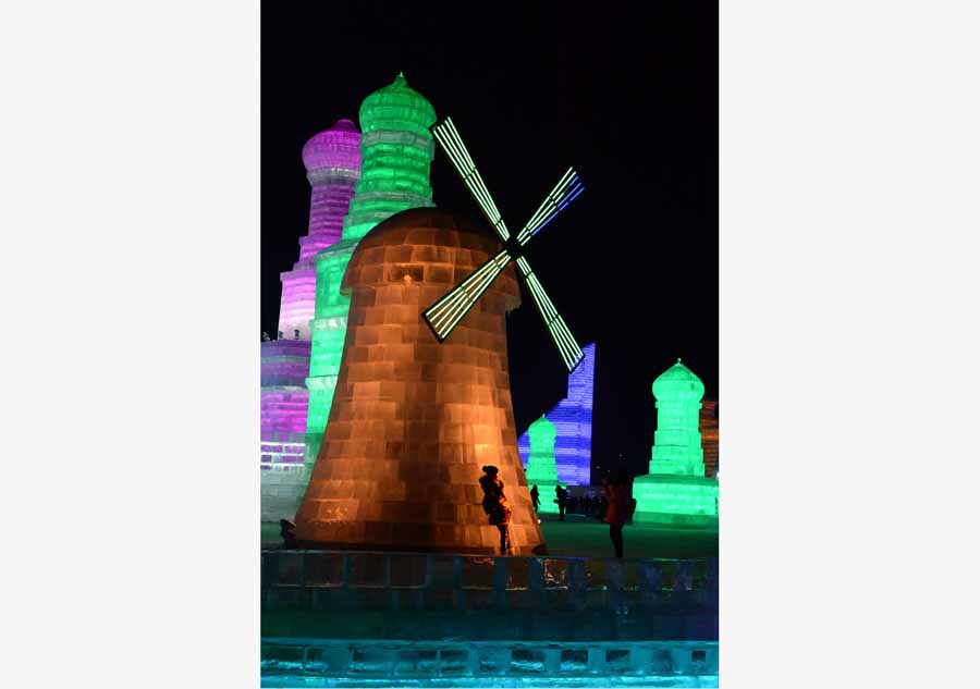 Tourists view shimmering ice sculptures in China's Harbin