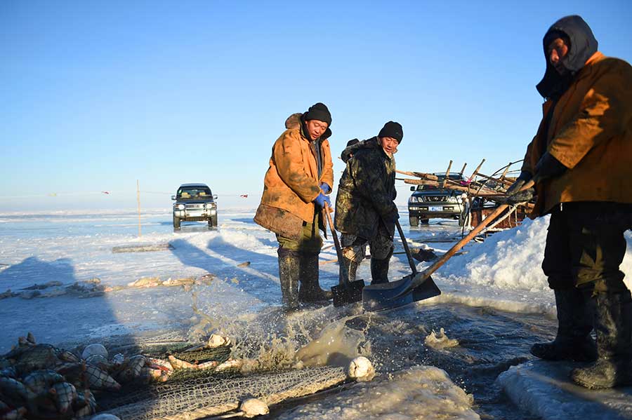 Winter fishing in ice-covered Hulun Lake in Inner Mongolia