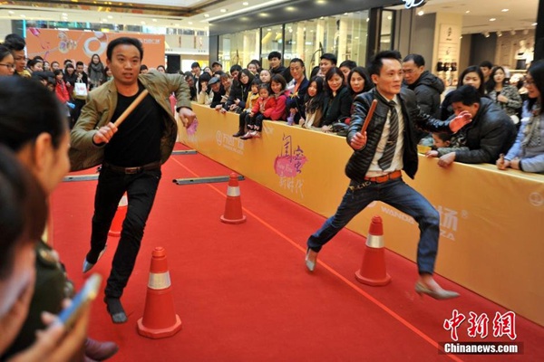 men running in high heels for women's day