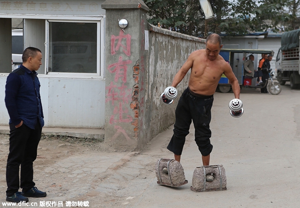 Middle-aged man exercises with stones on his feet