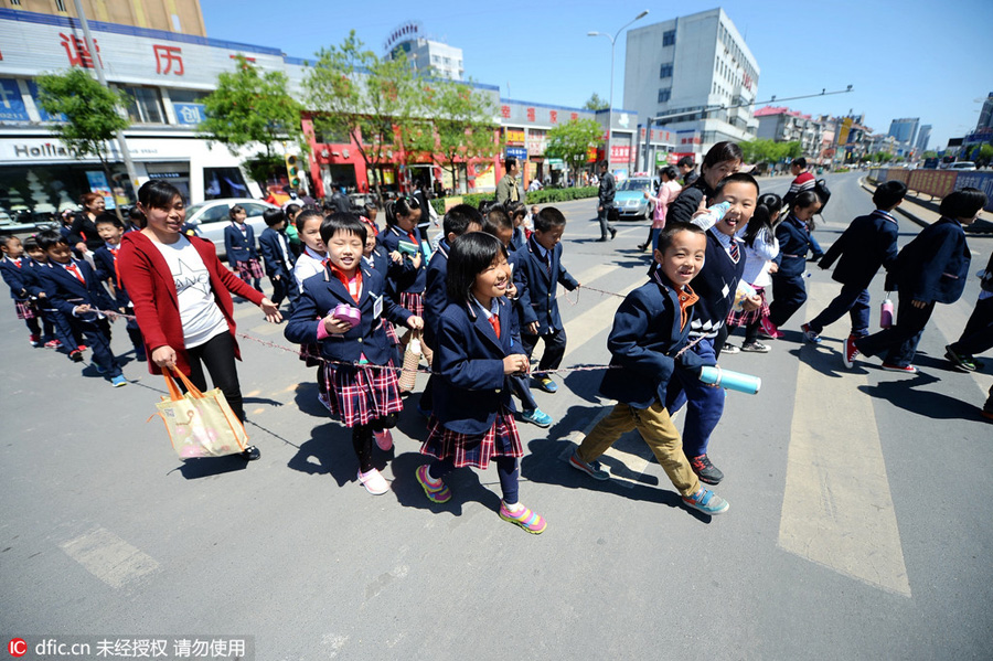 Students walk in rope circle to cross street